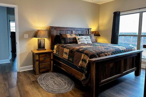 a bedroom with a bed and a lamp on a night stand at Shady Pines in Gatlinburg