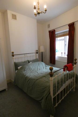 a bedroom with a bed and a window at The South View in London