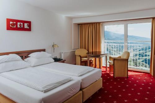 a hotel room with a bed and a large window at Hotel Friesacherhof in Prebl