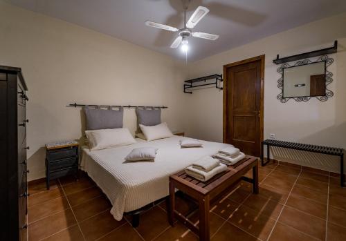 a bedroom with a bed and a ceiling fan at Sant'Agata in Lixouri