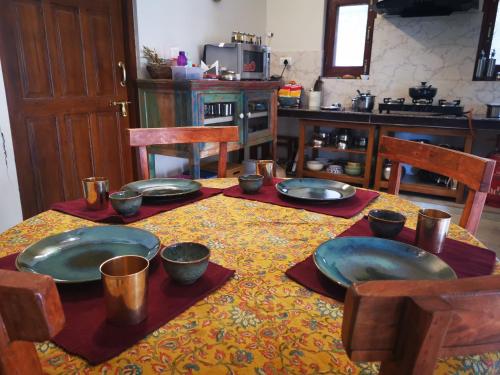 a table with plates and bowls on top of it at Villa by Mountain Homes- Lansdowne in Lansdowne