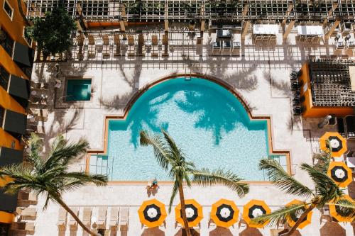 an overhead view of a swimming pool at a resort at The Atlantic Suites on the Ave in Delray Beach