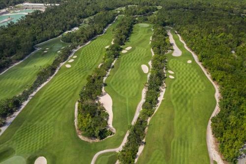 an overhead view of a golf course with trees at Iberostar Waves Tucan - All Inclusive in Playa del Carmen
