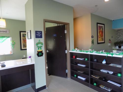 a bathroom with a sink and a shelf of shoes at Moulton Inn & Suites 