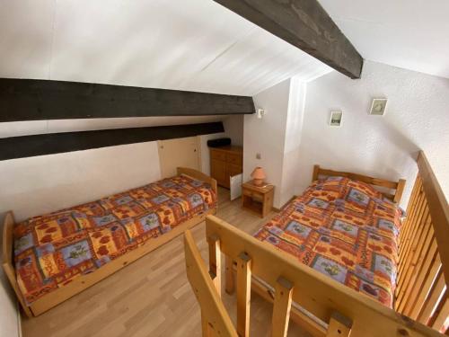 - une vue de tête sur deux lits dans une chambre dans l'établissement Appartement pour 6 avec Mezzanine près plage au Barcarès - FR-1-81-147, à Port-Leucate