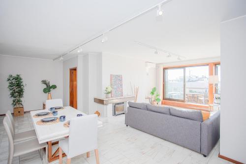 a living room with a couch and a table at Liiiving in Porto | Sea & River View in Porto