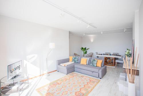 a living room with a couch and a table at Liiiving in Porto | Sea & River View in Porto
