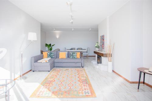 a living room with a couch and a table at Liiiving in Porto | Sea & River View in Porto