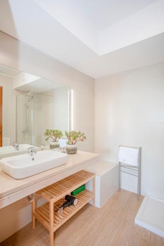 a bathroom with a sink and a large mirror at Liiiving in Porto | Sea & River View in Porto