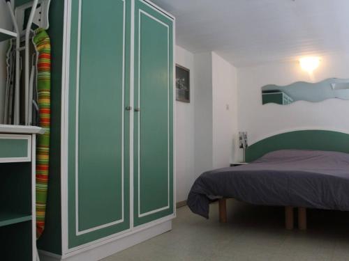 ラ・ロシェルにあるAppartement La Rochelle, 1 pièce, 4 personnes - FR-1-246-77のベッドルーム1室(ベッド1台付)、緑のキャビネットが備わります。