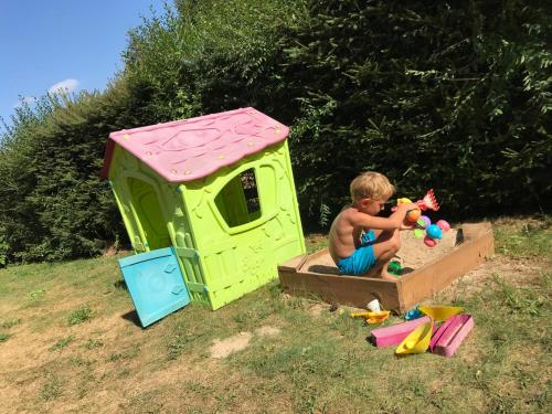 a young boy playing in a play house at Domek letniskowy nad jeziorem mazury Wilimy 127 in Wilimy