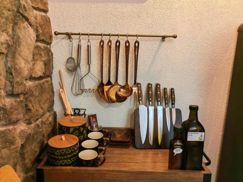 ein Holzregal mit Küchenutensilien neben einer Wand in der Unterkunft House for rent Didova kuća in Makarska