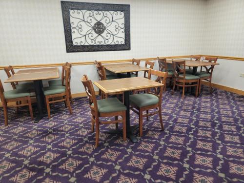 a dining room with wooden tables and chairs at Bay Mountain Inn Cherokee Smoky Mountains in Cherokee