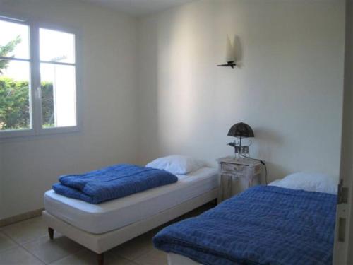 une chambre avec deux lits et une fenêtre dans l'établissement Villa moderne à Saint Georges d'Oléron, 8 couchages, proche mer et commerces, parking et jardin - FR-1-246A-7, à Chaucre