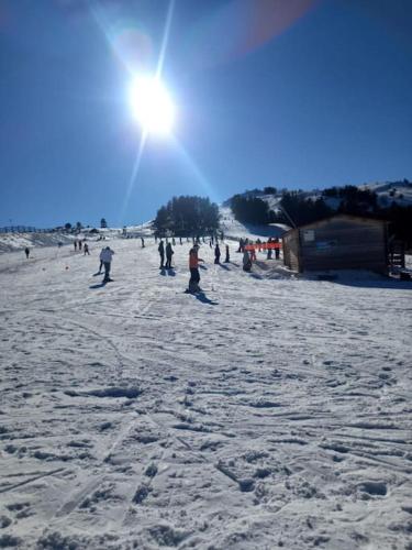 a group of people standing on a snow covered beach at Gîte l'Enclos Ô rendez-vous Roquefeuil-Pays de sault- avec jardin in Roquefeuil