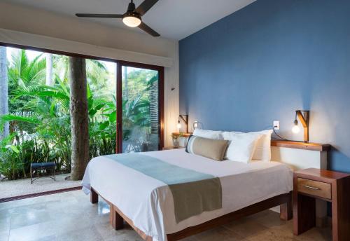 a bedroom with a large bed and a large window at Punta Monterrey in Lo de Marcos