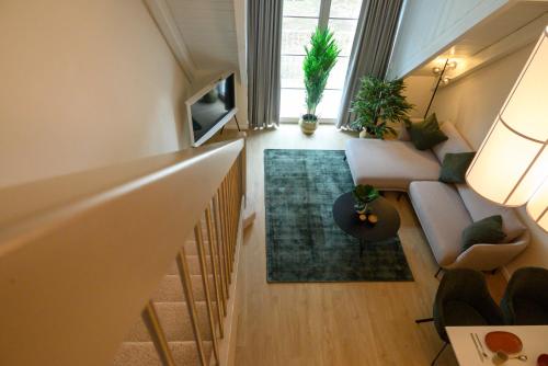 a room with a staircase with a couch and a living room at InselMühle in Munich