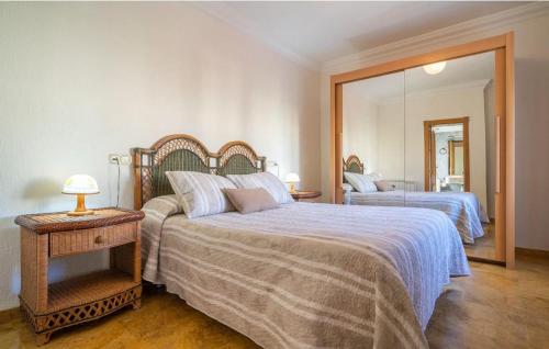 a bedroom with two beds and a large mirror at El Pino Cajar Granada in Cájar