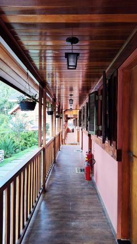 an empty hallway of a building with a wooden ceiling at Pousada Casa dos Sonhos in Campos do Jordão