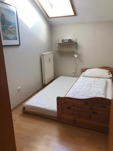 a small bedroom with a bed and a skylight at Ferienresidenz Am weißen Regen in Bad Koetzting