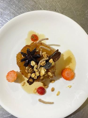 a white plate with a dessert with fruit and nuts at Essence Arenal Spa & Yoga in El Castillo de La Fortuna