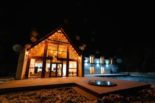 a house at night with a circle in front of it at Scrind 11 - Madleine Chalet in Cluj-Napoca