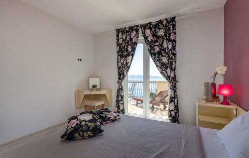 a bedroom with a bed and a window with a desk at E&M in Senj