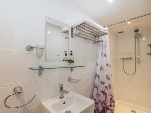 a bathroom with a sink and a shower at The Coach House in Somerton