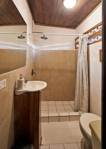 a bathroom with a sink and a toilet at Havana Lodge in Mal País