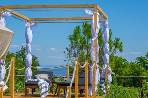 a gazebo with chairs on a deck at Floria Glamping Garden in Labin