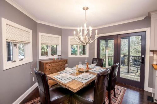 a dining room with a table and chairs and a chandelier at 1eight3 Retreat in Blowing Rock