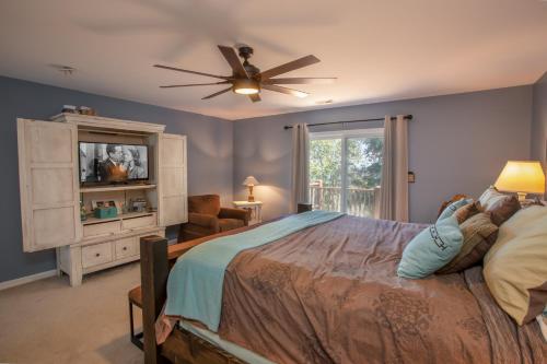 a bedroom with a bed and a ceiling fan at Ace of Diamonds in Seven Devils