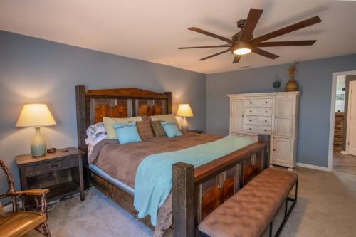 a bedroom with a bed and a ceiling fan at Ace of Diamonds in Seven Devils