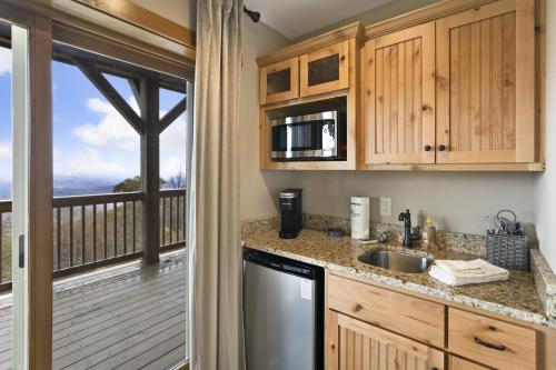 a kitchen with a view of a deck at Almost Heaven in Boone