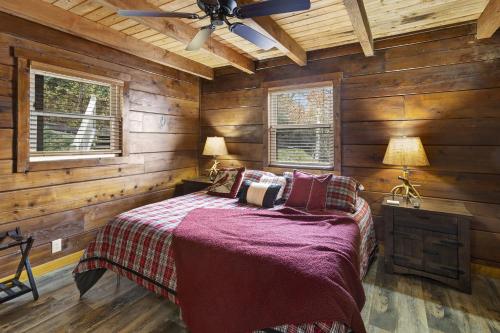 a bedroom with wooden walls and a bed in a room at Almost Heaven in Boone