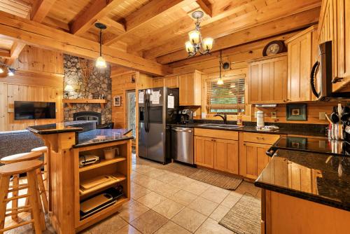 a large kitchen with wooden cabinets and stainless steel appliances at Almost There in Blowing Rock