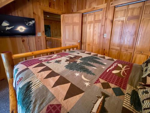a bedroom with a bed with a quilt on it at Almost There in Blowing Rock