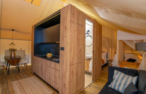 a room with a large wooden partition in a bedroom at Floria Glamping Garden in Labin