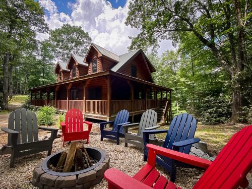 a group of chairs sitting in front of a log cabin at Almost There in Blowing Rock