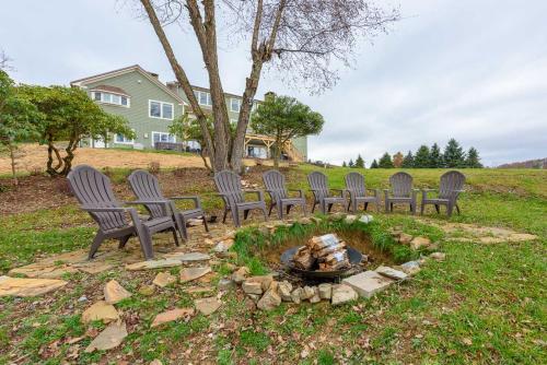 a group of chairs sitting around a fire pit at Appalachian Mountain Lodge in Boone