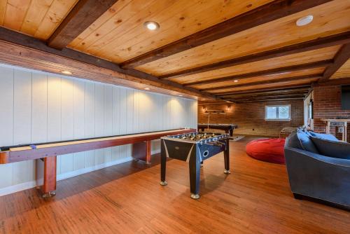 a living room with a ping pong table and a ping pong table at Appalachian Mountain Lodge in Boone