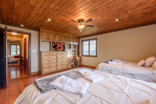 a bedroom with two beds and a ceiling fan at Appalachian Mountain Lodge in Boone
