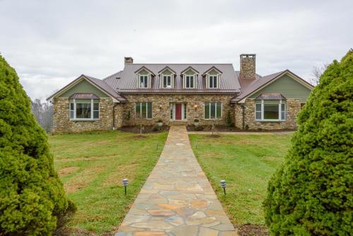 a stone house with a pathway leading to it at Appalachian Mountain Lodge in Boone