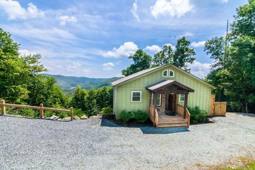 a small green building with a porch and a deck at Appalachian Ski Mountain Chalet in Blowing Rock