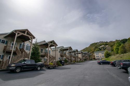 a truck parked in front of a row of houses at Bear Necessities in Beech Mountain