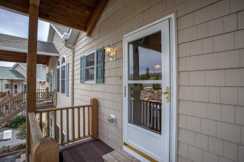a porch with a white door on a house at Bear Necessities in Beech Mountain
