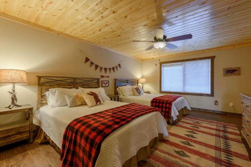 a bedroom with two beds and a ceiling fan at Bear The View in Seven Devils