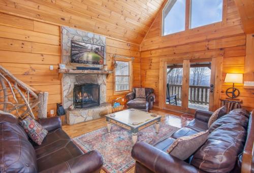 a living room with leather furniture and a fireplace at Beech View Retreat in Zionville