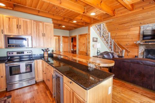 a kitchen with wooden cabinets and a stove top oven at Beech View Retreat in Zionville