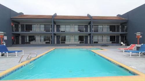 a large swimming pool in front of a hotel at South Padre Island Lodge in South Padre Island